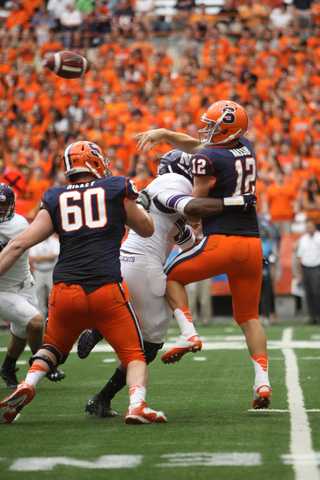 Ryan Nassib quarterback for Syracuse, is rushed as he tries to pass.