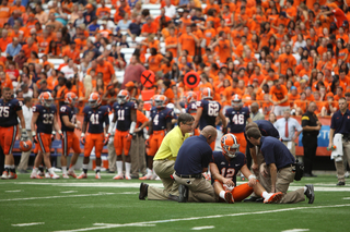 Syracuse quarterback Ryan Nassib sits on the ground after being injured in the first half.