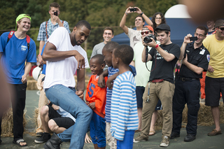 James Southerland, a forward on the SU basketball team, dances with local kids during a 