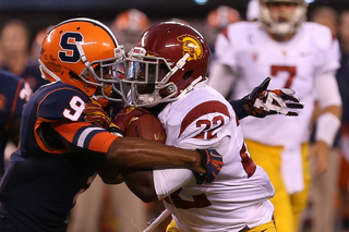 Syracuse Orange cornerback Ri'Shard Anderson #9 and USC Trojans running back Curtis McNeal #22 collide in the second half.  