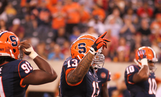 Syracuse Orange defensive tackle Deon Goggins #13 tries to pump up the crowd in the third quarter. 