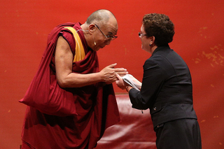 The Dalai Lama greets SU Chancellor Nancy Cantor at Monday morning's 