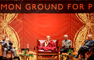 The Dalai Lama listens to the other panelists, as he stated repeatedly that he wants to 