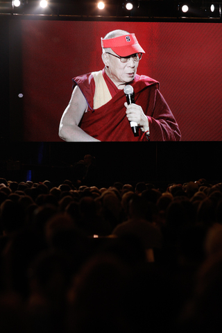 The Dalai Lama wore a Syracuse University visor as he spoke to the audience.