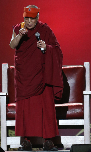The Dalai Lama speaks to the crowd in the Carrier Dome on Tuesday night.