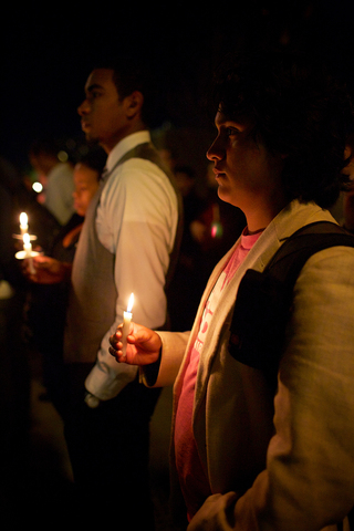 Iggy Nava, a sophomore international relations major, watches during the candlelight vigil.