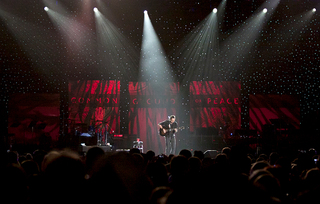 The spotlights shine on Dave Matthews as he performs his set during the One World Concert.