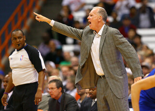 Head coach Doug Collins of the Philadelphia 76ers gestures toward the court during the preseason game against the New York Knicks.