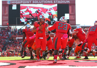 Rutgers quarterback Gary Nova hands to running back Jawan Jamison as Rutgers tries to get out of its own end zone.