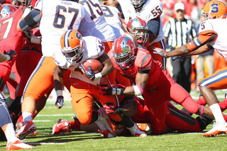 Syracuse running back Jerome Smith is dragged down by a defender.