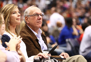 Syracuse head coach Jim Boeheim, with his wife Juli, watches the NBA preseason game between the New York Knicks and the Philadelphia 76ers at the Carrier Dome.