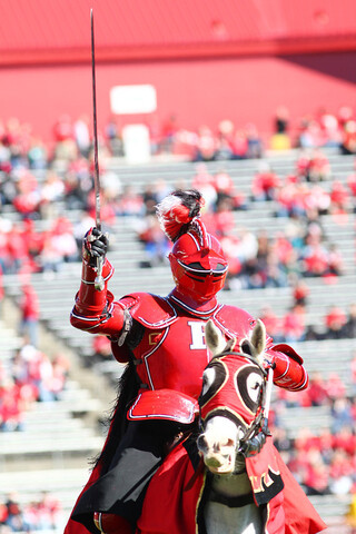 Rutgers' knight mascot comes out on the field on a horse before the game.
