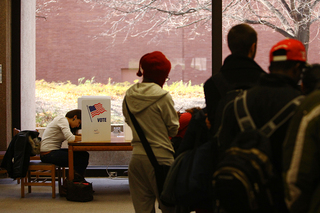 (Left) Alessia Haddad, a sophomore architecture major, votes in Bird Library Tuesday.