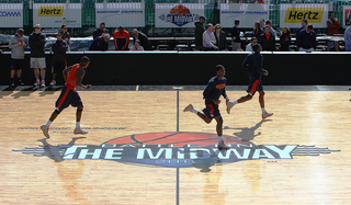 Syracuse players run on the court over the Battle on the Midway logo during media day on Nov. 10, 2012 before Sunday's Battle on the Midway game against the San Diego State Aztecs aboard the USS Midway.