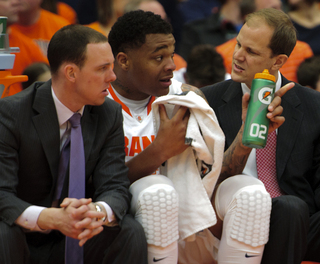 Syracuse forward DaJuan Coleman (center) speaks with assistant coach Mike Hopkins (right).