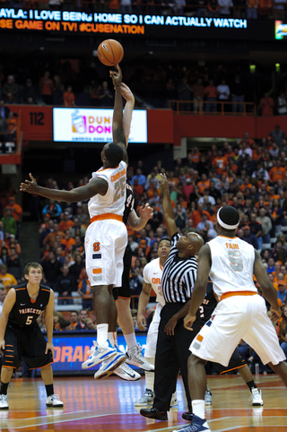 Syracuse center Rakeem Christmas and Princeton center Brendan Connolly go up for the opening tip.