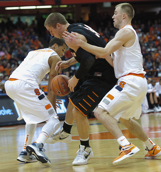Michael Carter-Williams (left) tries poking the ball away from Princeton's Ian Hummer.