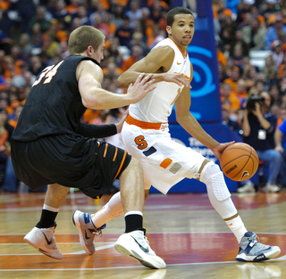 Syracuse guard Michael Carter-Williams is guarded closely by Princeton forward Ian Hummer.