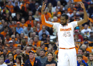 Syracuse forward James Southerland signals the Carrier Dome crowd to stand up. Southerland led SU, scoring a career-high 22 points.