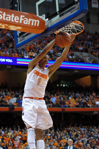 Syracuse guard Michael Carter-Williams puts home a dunk to finish a fast break.