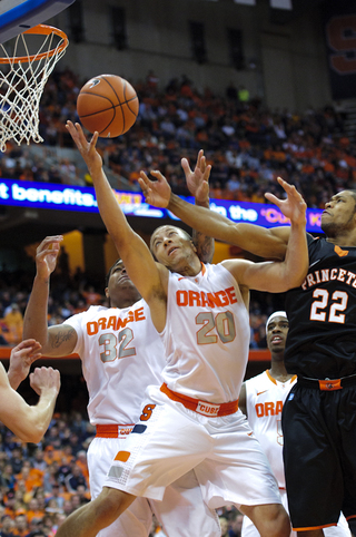 Syracuse guard Brandon Triche battles with Princeton guard Chris Clement for a rebound.