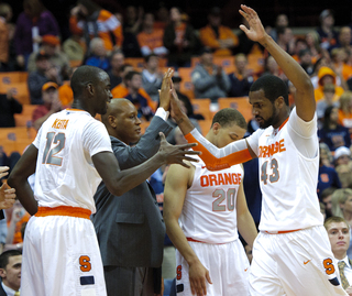 Syracuse forward James Southerland comes off the court and slaps five with teammates.