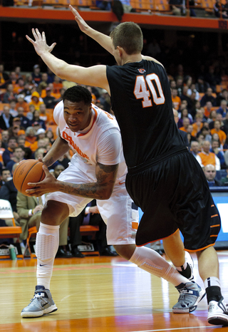 DaJuan Coleman attempts to duck under Princeton center Bobby Garbade on his way to the basket.