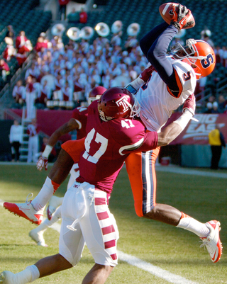 Syracuse wide receiver Marcus Sales leaps to bring in a touchdown reception over Temple defensive back Anthony Robey.