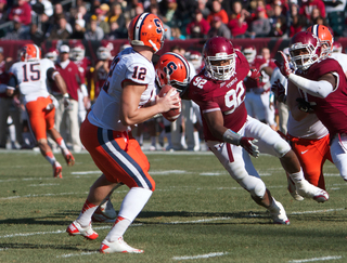 Syracuse quarterback Ryan Nassib looks upfield while facing pressure from the Temple defensive line.