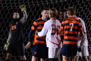 Syracuse's Ted Cribley gets in a confrontation with Cornell midfielder Conor Goepel (38) on Thursday night.