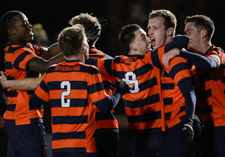Jordan Vale (2), Stefanos Stamoulacatos (9) and Louis Clark celebrate their 1-0 victory over Cornell on Thursday. The Orange advances to the second round of the NCAA tournament to take on No. 14 VCU in Richmond, Va.