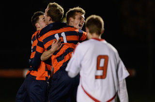 Lars Muller (11) celebrates with teammates following SU's NCAA tournament win in Ithaca, N.Y. Muller scored the decisive goal in the Orange's 1-0 win over Cornell.