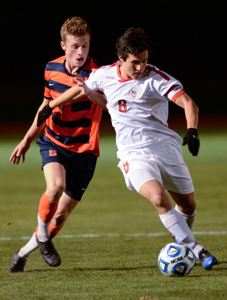 Louis Clark tries to take the ball from Cornell's Nico Nissl during SU's first-round NCAA tournament game Thursday night.