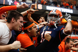 Syracuse wide receiver Alec Lemon celebrates with fans following the Orange's upset win over Louisville.