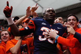Syracuse linebacker Dyshawn Davis celebrates with the Carrier Dome crowd following SU's 45-26 win over Louisville.
