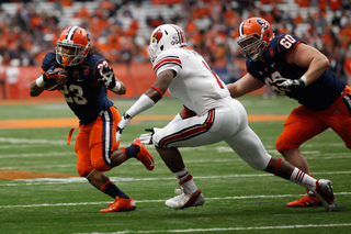 Syracuse running back Prince-Tyson Gulley attempts to dodge a defender.