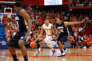 Syracuse guard Michael Carter-Williams dribbles past Monmouth's Ed Waite. Carter-Williams finished the game with 16 assists.