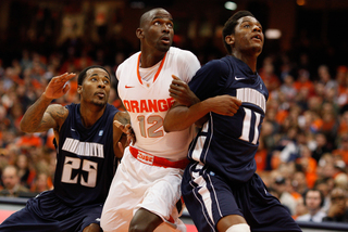 Center Baye Moussa tangles with Monmouth's Khalil Brown in Syracuse's win over the Hawks.