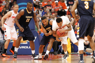 DaJuan Coleman fights for possession with Canisius guard Alshwan Hymes.