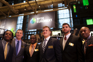 Syracuse players Shamarko Thomas, Siriki Diabate, Ryan Nassib and Justin Pugh stand with head coach Doug Marrone and Athletic Director Daryl Gross at the New York Stock Exchange.