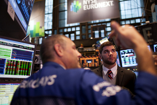Syracuse offensive lineman Justin Pugh looks up from the floor of the New York Stock Exchange.