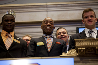 From left: Linebacker Siriki Diabate, Athletic Director Daryl Gross and quarterback Ryan Nassib smile at the New York Stock Exchange. Representatives from Syracuse and West Virginia were there to ring the opening bell on Thursday.