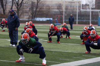 Syracuse running back Jerome Smith (front) stretches along with the rest of his teammates in practice at Columbia University on Thursday.