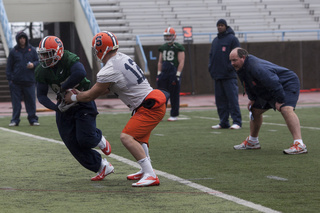Ryan Nassib hands the ball off to Jerome Smith at practice Thursday.