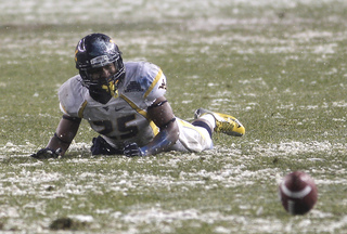 Darwin Cook, a safety for West Virginia, looks at the ball he almost intercepted.  Syracuse takes on West Virginia in the 2012 Pinstripe Bowl at a snowy Yankee Stadium on Saturday, December 29, 2012 in New York, New York.