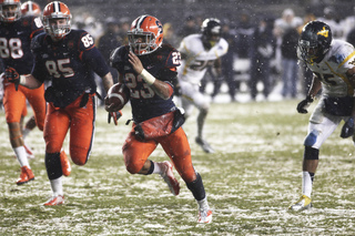 Prince-Tyson Gulley #23, a running back for Syracuse, runs for a touchdown.  Syracuse takes on West Virginia in the 2012 Pinstripe Bowl at a snowy Yankee Stadium on Saturday, December 29, 2012 in New York, New York.