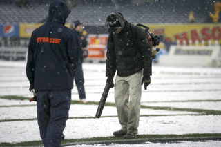 Yankee Stadium staff blows snow from the field. Syracuse takes on West Virginia in the 2012 Pinstripe Bowl at a snowy Yankee Stadium on Saturday, Dec. 29, 2012, in New York City. 