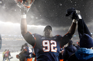 Defensive tackle Davon Walls raises his arms in celebration after the game. 