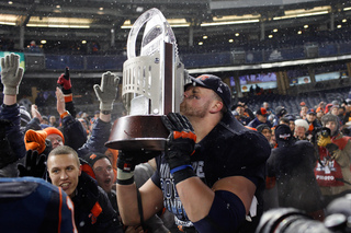 Zack Chibane kisses the Pinstripe Bowl trophy after the game.