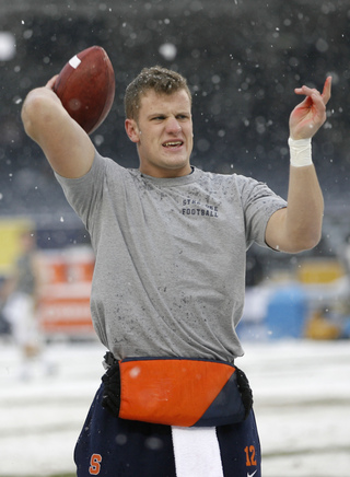 Ryan Nassib warms up before the game. The weather brought snow to Yankee Stadium on Saturday before the Pinstripe Bowl between Syracuse and West Virginia.